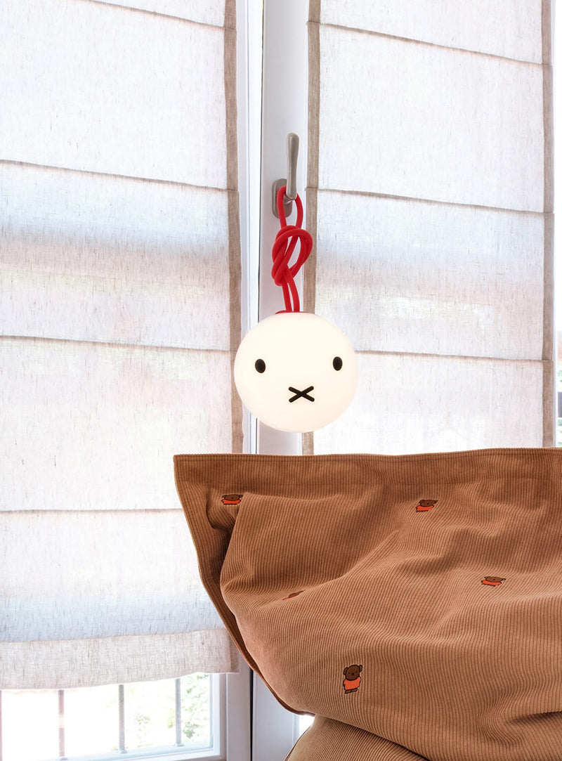 Fatboy Bolleke x Miffy lamp casting a warm glow in a cozy nursery or living room, adding charm and comfort.